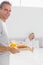 Happy man bringing breakfast in bed to his partner