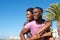 Happy man carrying girlfriend outdoors