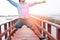 Happy man in casual jeans on wooden bridge