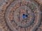 Happy man on crop circle in oat field, aerial view