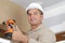 Happy man drilling wall with drill perforator