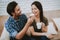 Happy Man Feeding Sandwich Smiling Woman with Cup