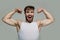 Happy man flex muscles, biceps, triceps on grey background