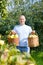 Happy man gathers apples