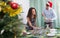 Happy man and girl serving Christmas table for guests