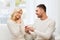 Happy man giving engagement ring to woman at home