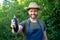 happy man greengrocer in straw hat with eggplant vegetable