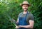 happy man greengrocer in straw hat with green onion vegetable