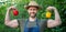 happy man greengrocer in straw hat with sweet pepper