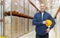 Happy man with hardhat over warehouse