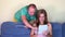 Happy man help his girlfriend using tablet computer device on couch. closeup