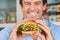 Happy Man Holding Bugger In Grocery Store