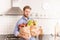 Happy man holding paper grocery shopping bag in the kitchen