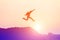 Happy man jumping against beautiful sunset. Freedom, enjoyment concept