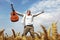 Happy man jumping in a wheat field