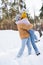 Happy man lifting girlfriend in snow
