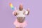 Happy man with overweight in fairy costume holds duster and detergent on purple background