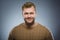 Happy man. Portrait of handsome man smiling isolated on grey background