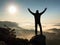 Happy man with raised arms gesture triumph on exposed cliff. Satisfy hiker