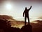 Happy man with raised arms gesture triumph on exposed cliff. Satisfy hiker