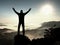 Happy man with raised arms gesture triumph on exposed cliff. Satisfy hiker