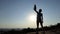 Happy man raises many medals at sunset in summer in slo-mo