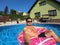 Happy man relax on inflatable ring. Holiday 2020