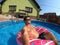 Happy man relax on inflatable ring. Holiday 2020