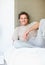 Happy man relaxing in bed. Portrait of handsome mature man sitting comfortably on bed.