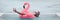 Happy man relaxing in swimming pool flamingo float despite bad rain weather. Travel summer vacation banner.