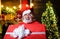 Happy man in santa costume with Christmas gift. Smiling Santa Claus with big present. Delivery service.