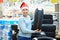Happy man in Santa hat with gift winter tires in store Christmas