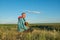 Happy man sitting with a dog in prairie