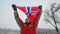 Happy man sport fan holds Flag of Norway waving in the wind