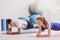 Happy man and sportswoman exercising on mat during physical training
