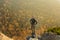 Happy man standing at the top of the mountain. Landscape view of misty autumn mountain hills and man silhouette