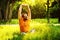 A happy man is stretching himself on green grass with squint eye