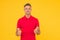 Happy man with stylish beard hair in red tshirt show thumbs ups satisfactory hand gesture yellow background