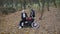 Happy man in sunglasses comes to his girl sitting on motorbike in park