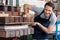 Happy Man Using Paper Press Machine In Factory