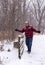 Happy man walking across a wooden bridge in the snow