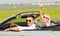 Happy man and woman driving in cabriolet car