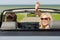 Happy man and woman driving in cabriolet car