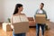 Happy man and woman holding cardboard boxes