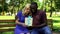 Happy man and woman holding gift box, present from beloved, celebrating birthday