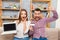 Happy man and woman screaming with laptop and bank card