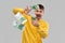 Happy man in yellow sweatshirt pouring money