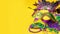 Happy Mardi Gras and Fat Tuesday carnival concept with close up on a face mask full of color, feathers and texture and golden,