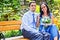 Happy married couple sitting on bench