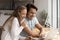 Happy married couple using laptop together at home workplace